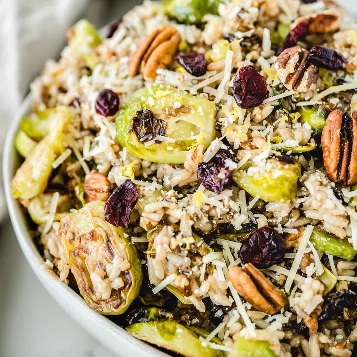 Close up of roasted brussels sprouts salad in a white bowl