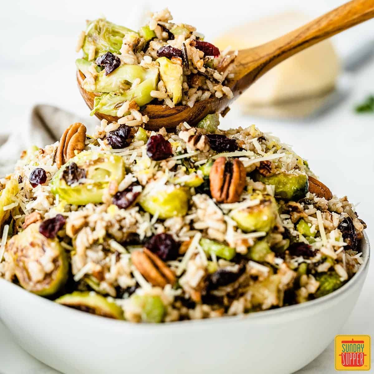 A wooden spoonful of roasted brussels sprouts salad