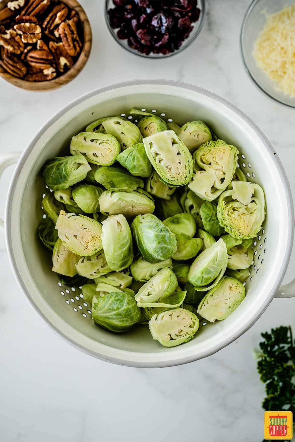Brussels sprouts in a white colander