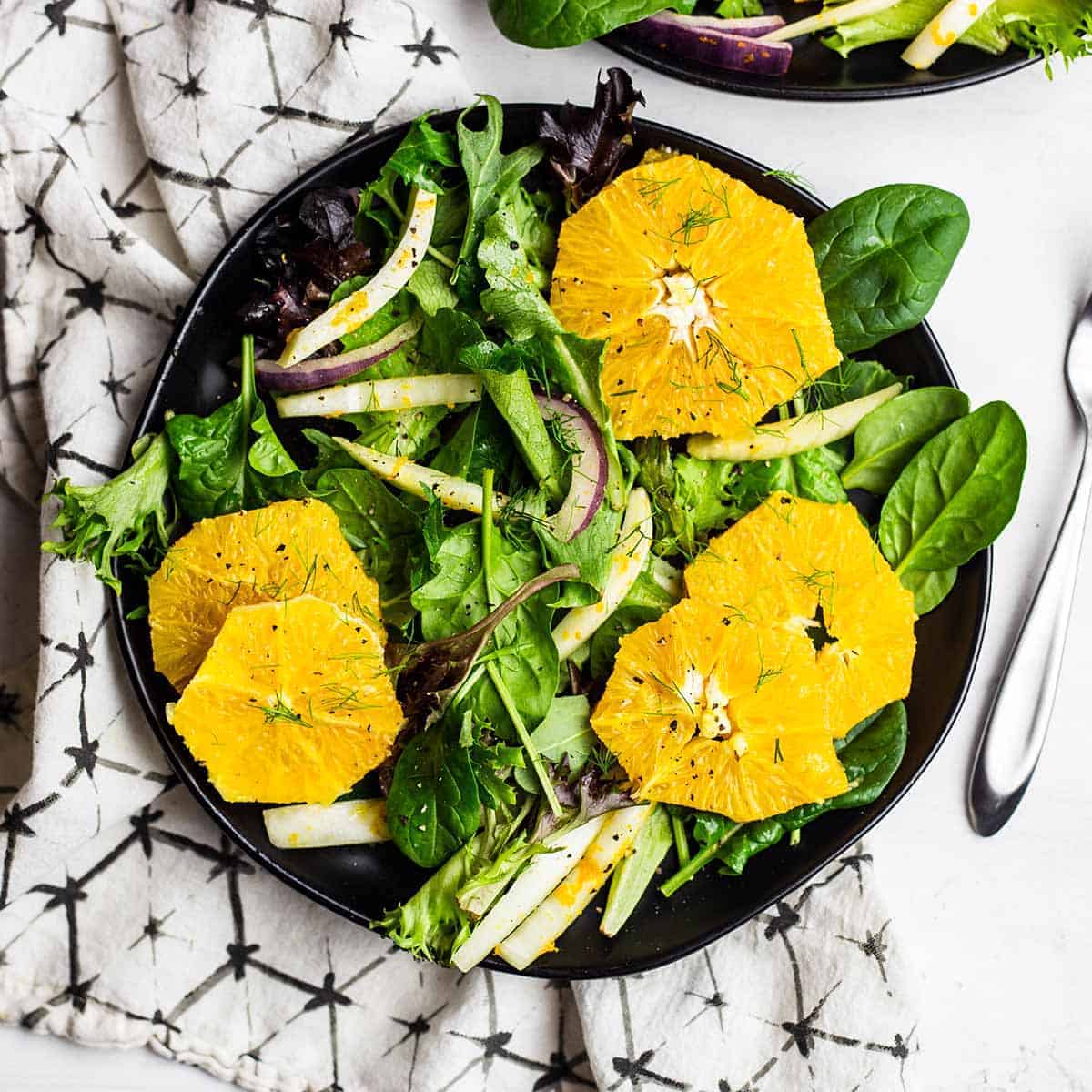 Orange and fennel salad on a black plate