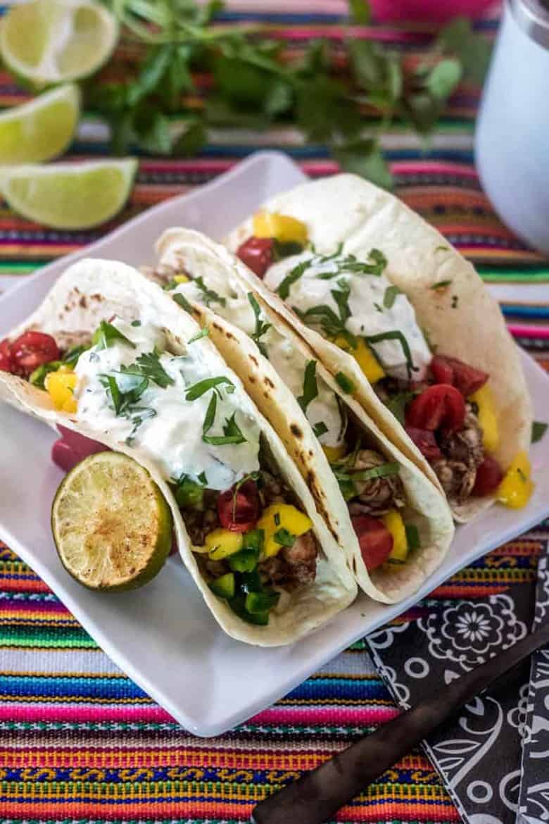 Indian street tacos served on a white plate
