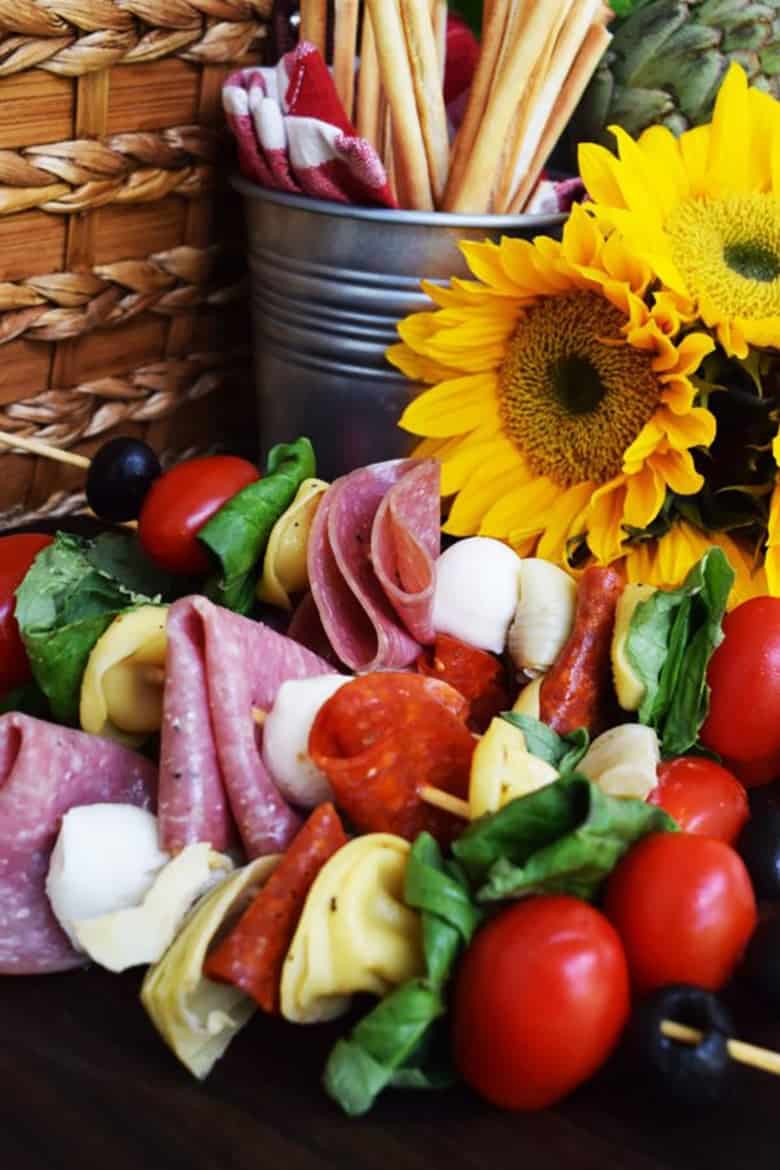 Antipasto skewers in front of sunflowers by Soulfully Made