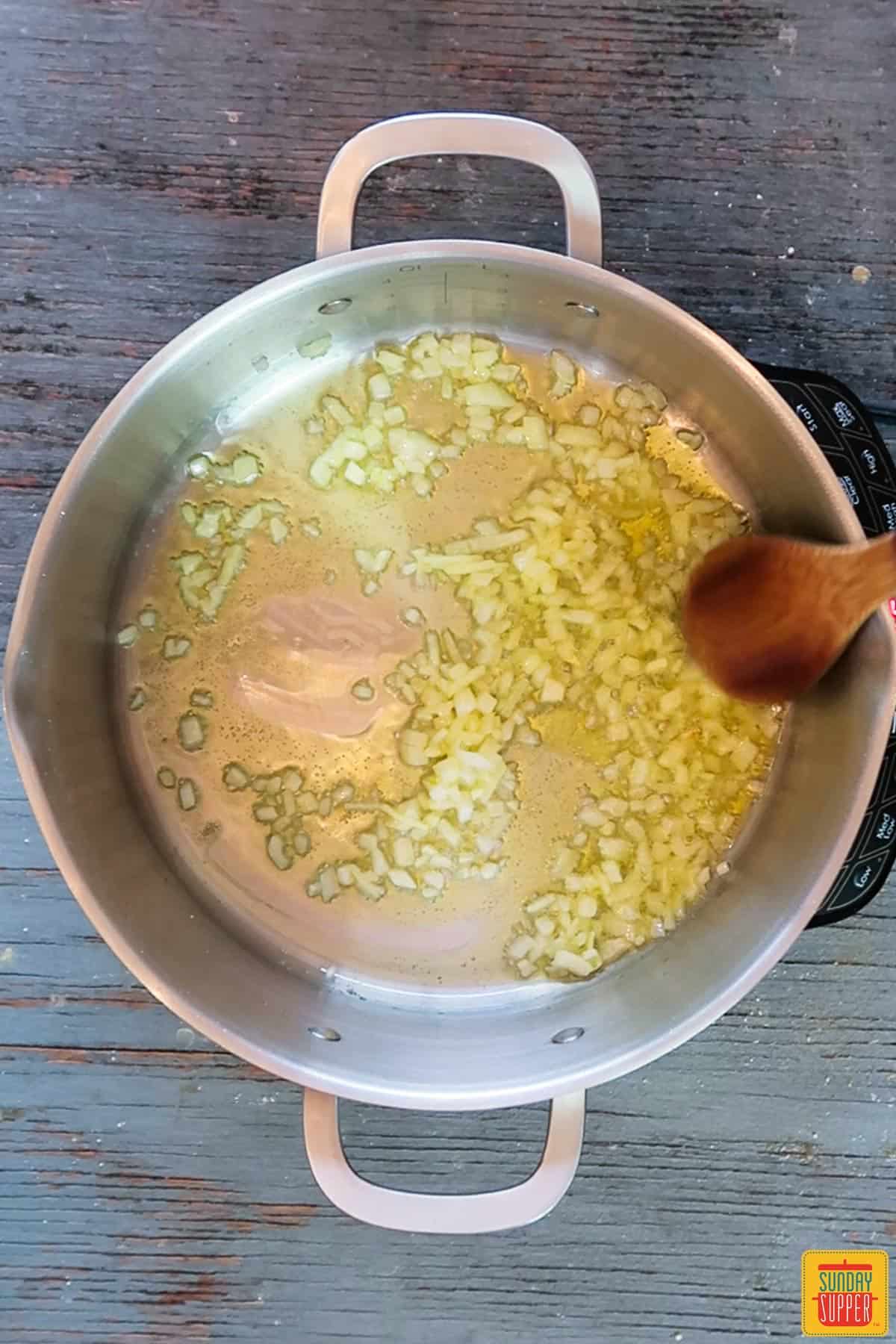 Cooking onions in a pot for Italian wedding soup