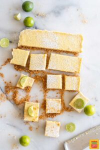 Key lime bars cut into slices next to the remaining uncut pieces of key lime pie
