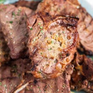 Grilled lamb chops stacked on top of each other close up