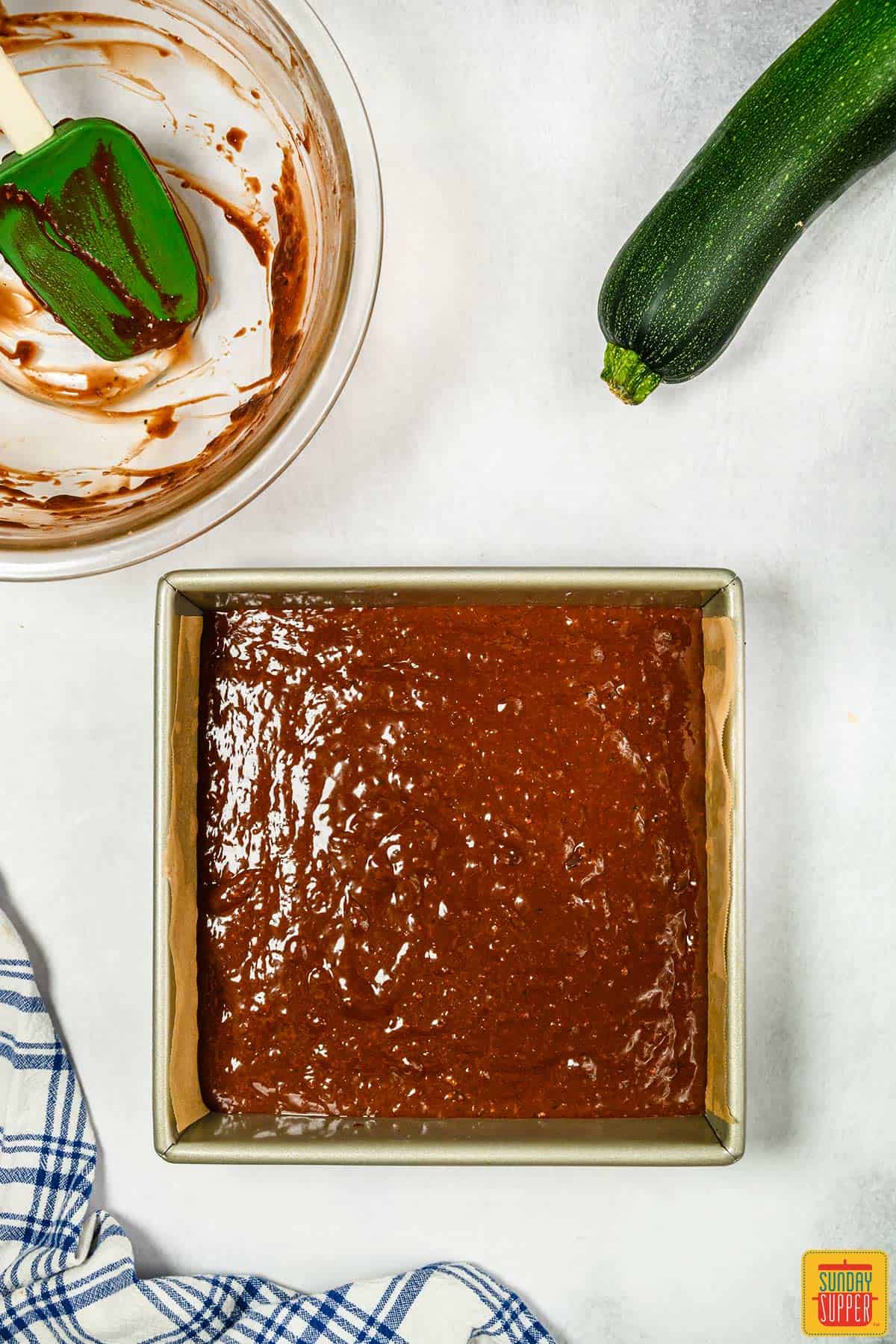 Zucchini brownie batter in a baking dish