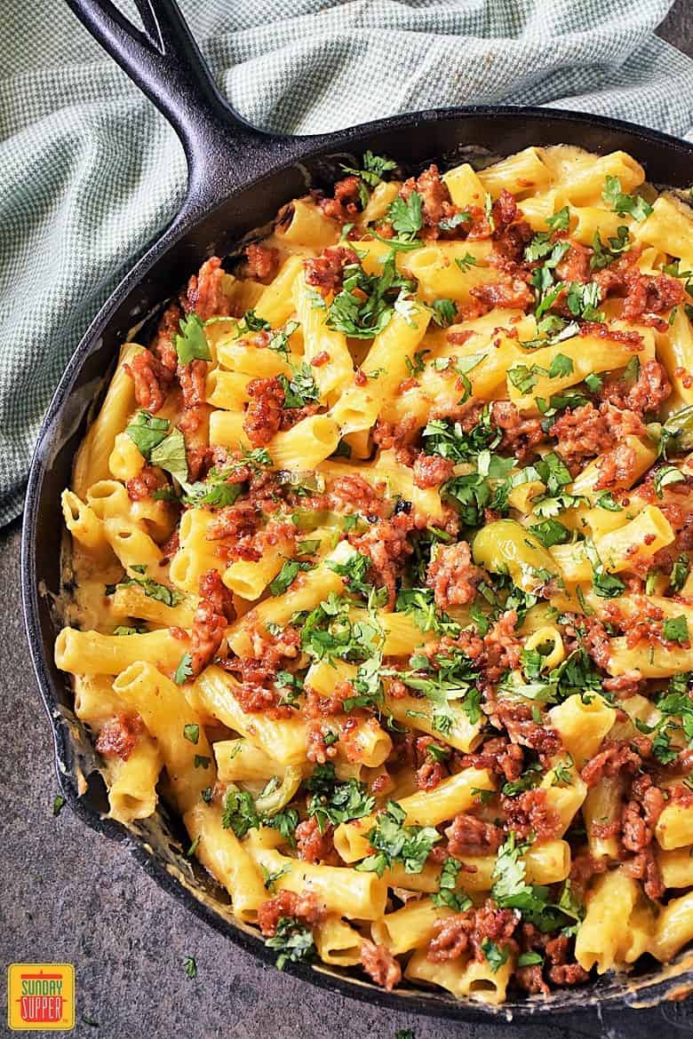 Baked ziti with sausage and peppers in a skillet