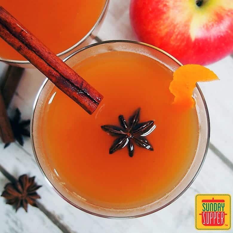 Top-down view of Spiked Mulled Cider in a glass with star anise and a cinnamon stick