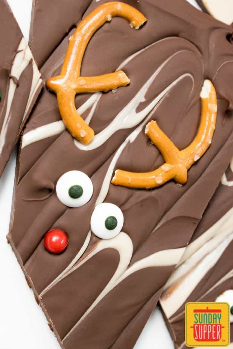 Chocolate caramel bark that looks like reindeer with pretzel antlers