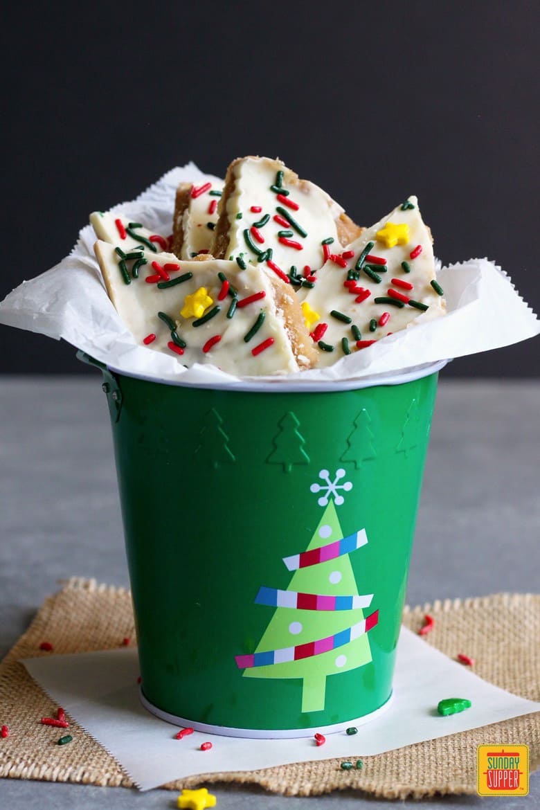 white chocolate saltine crack candy in a christmas bucket ready to eat
