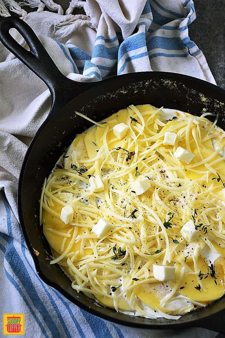Layering potatoes and cheese in skillet for potatoes au gratin