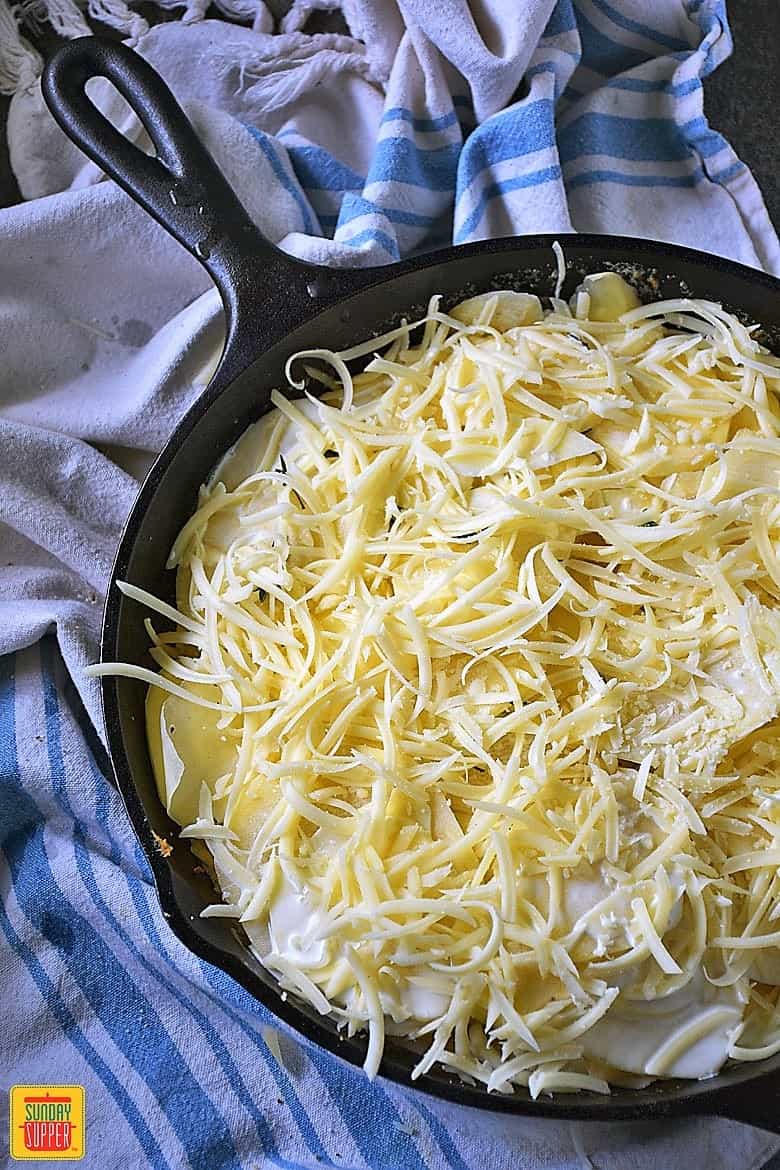 Cheese, potatoes, and cream in a skillet