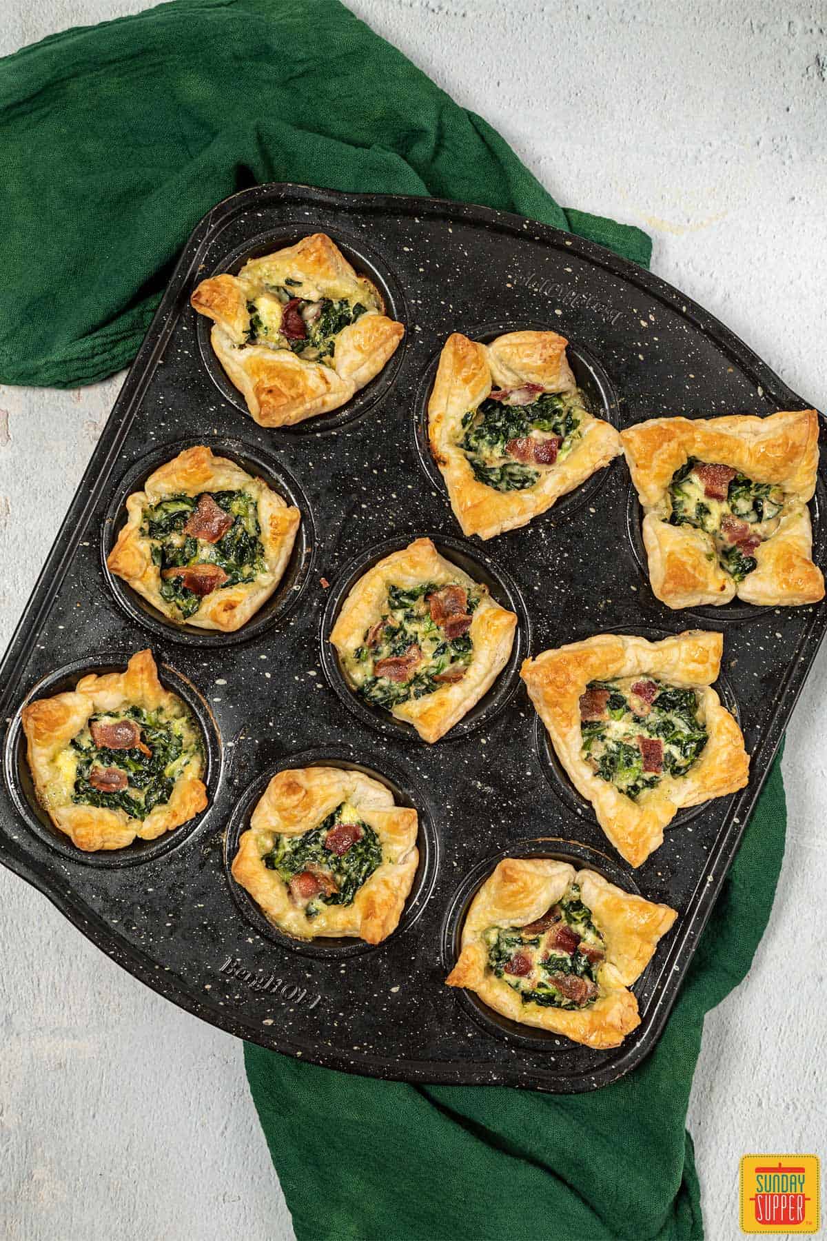 Muffin tin of spinach puff pastries
