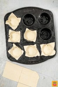 adding puff pastry to muffin tin
