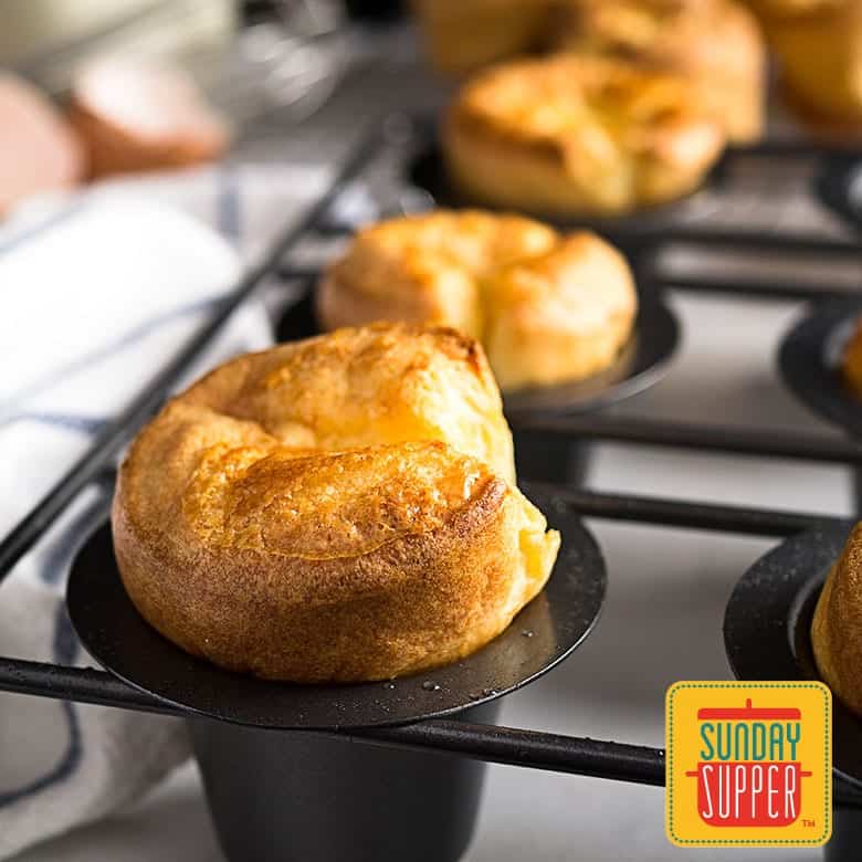 Cooked golden-brown Yorkshire puddings in a popover pan