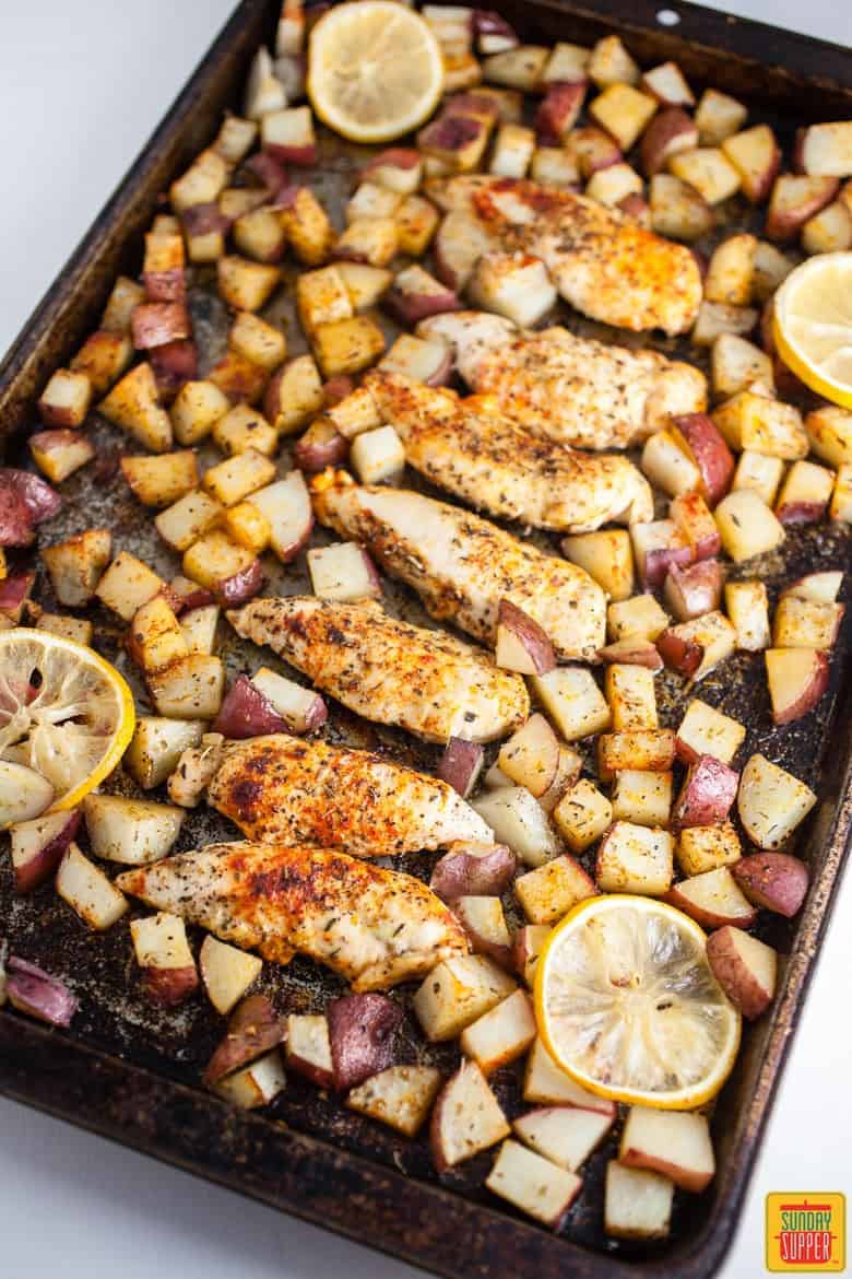 Greek chicken and potatoes on a baking sheet after roasting