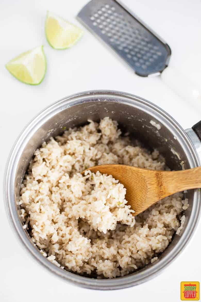 Cilantro lime rice in a bowl with a wooden spoon
