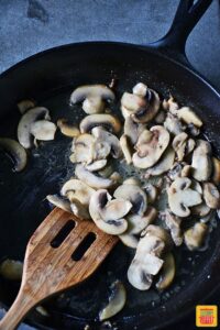Cooking mushrooms in a skillet for ground beef stroganoff recipe