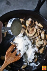 Adding flour to skillet with mushrooms to make ground beef stroganoff sauce