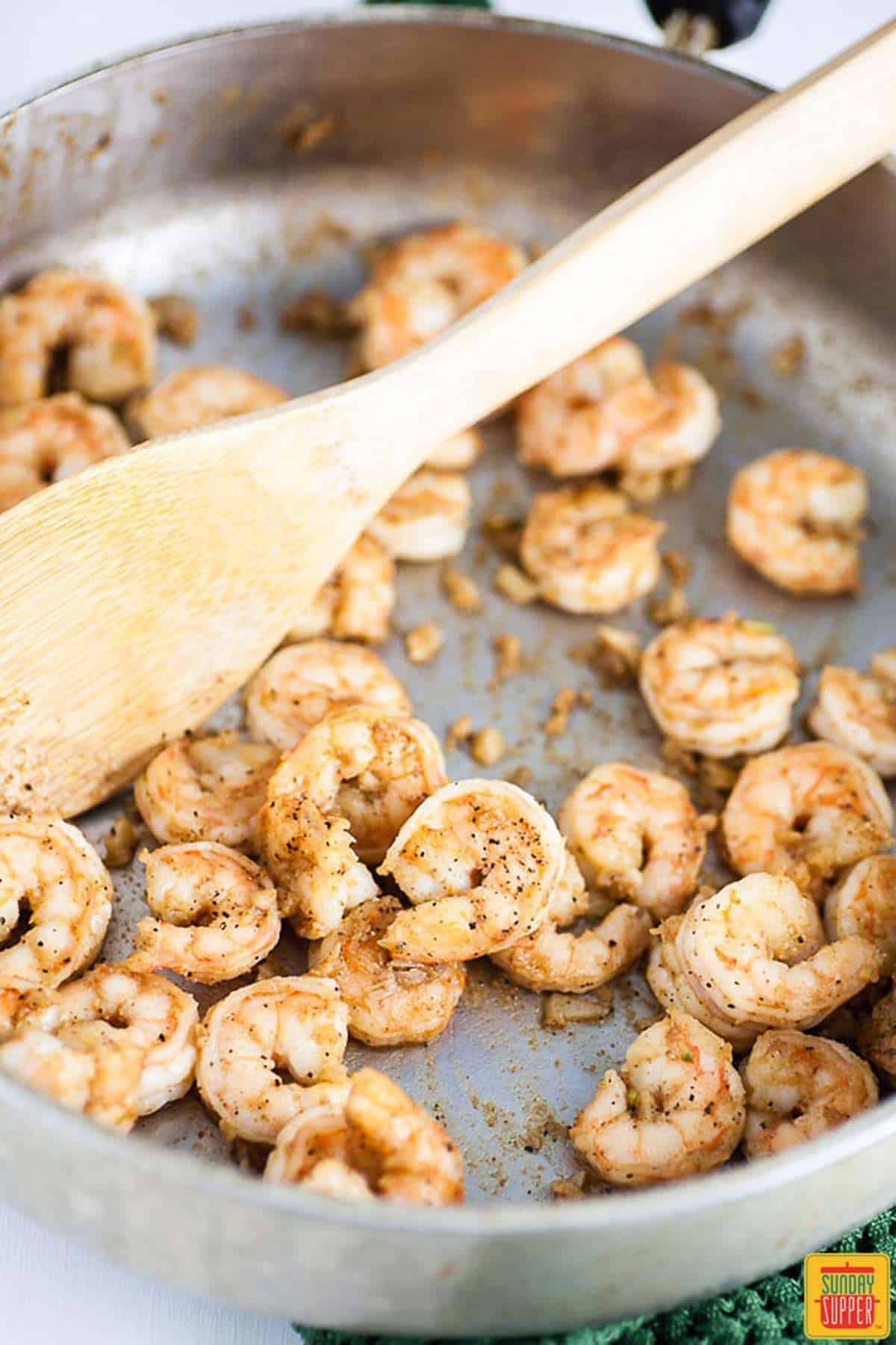 Shrimp sauteeing in a pan