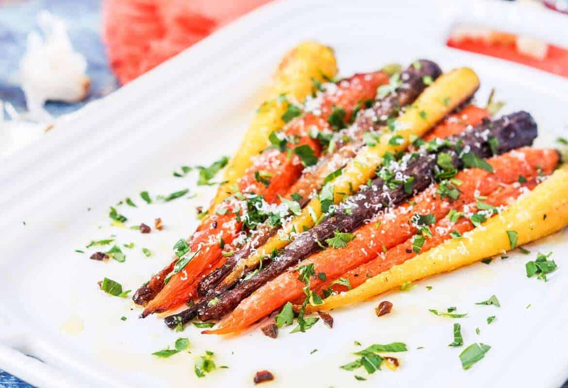 Parmesan Garlic Roasted Carrots on a white dish