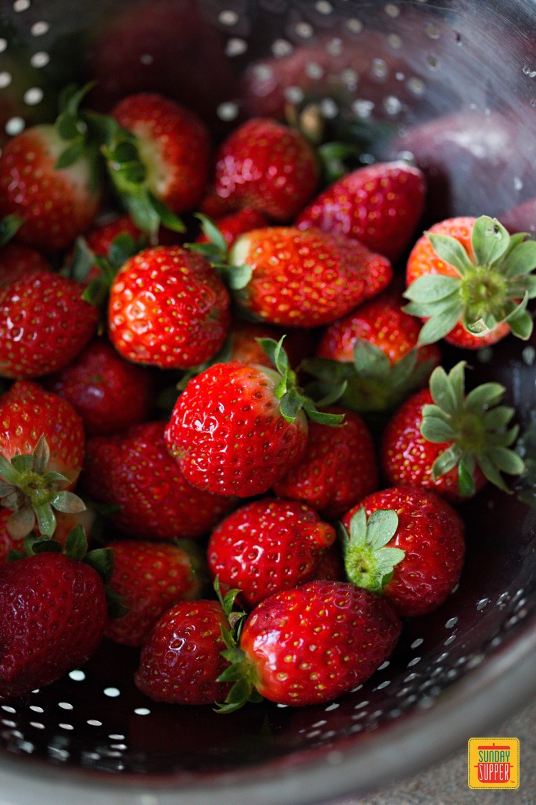 Fresh strawberries washed in a colander
