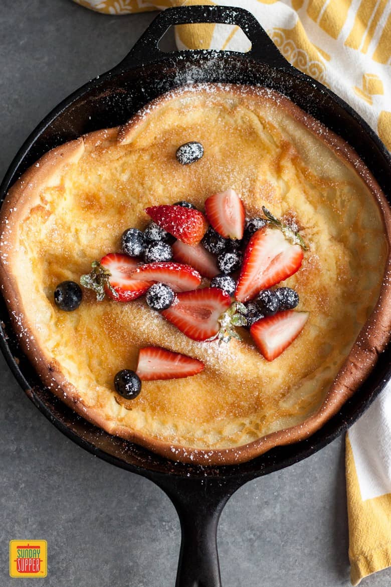 Berries and Cream Dutch Baby in a cast iron skillet 