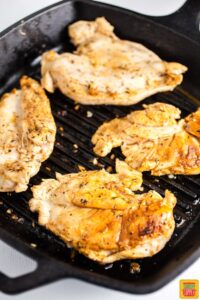 grilling chicken breasts in a pan