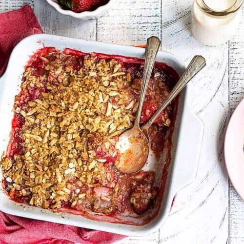 overhead view of strawberry crumble in ceramic baking dish