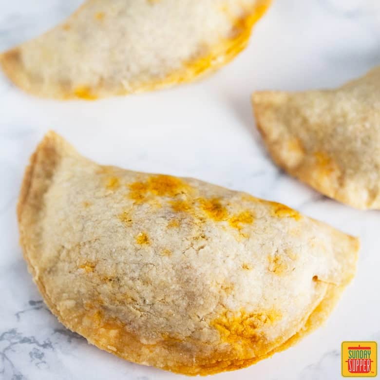 Puerto Rican Baked Empanadas Meat Pies on a white surface