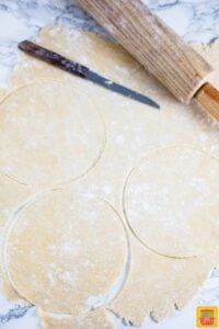 Cutting dough discs to make empanadas