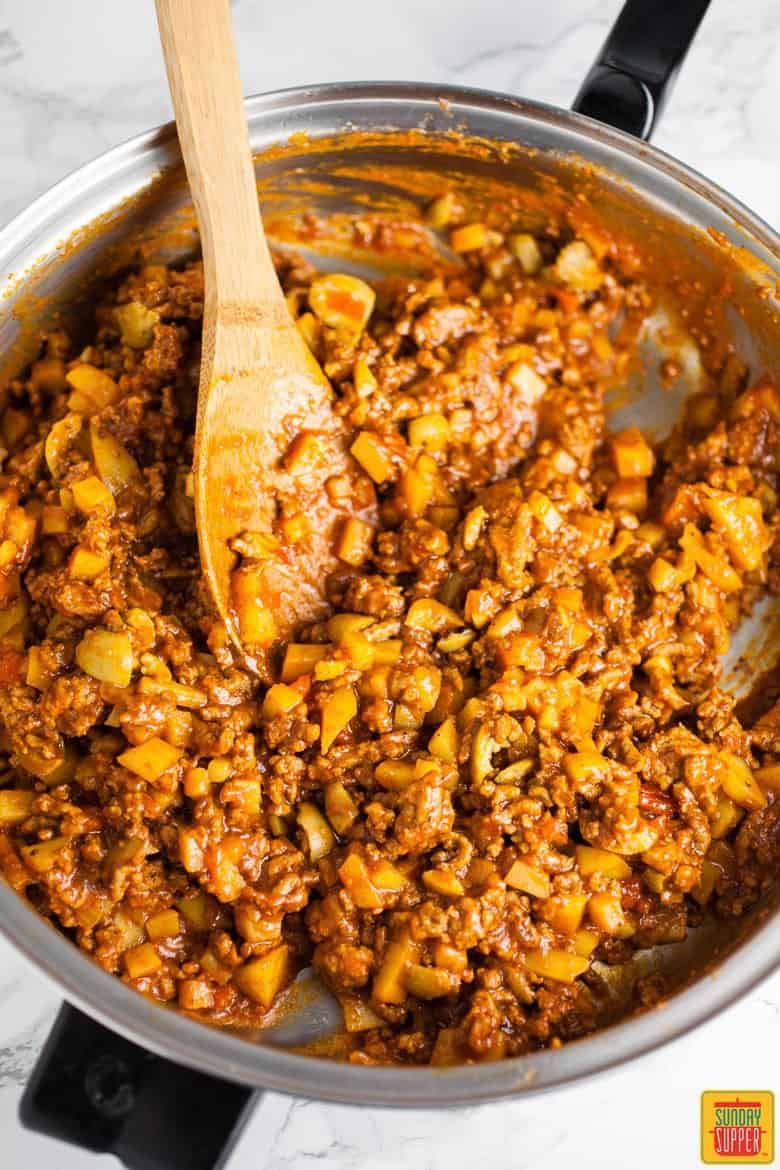 Preparing the filling in a skillet for the Puerto Rican Baked Empanadas Meat Pies