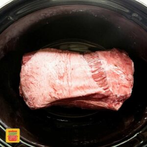 Slow cooker brisket fat-side up in thee slow cooker ready to cook
