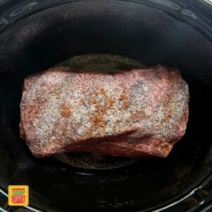 Seasoned brisket ready to cook in the slow cooker