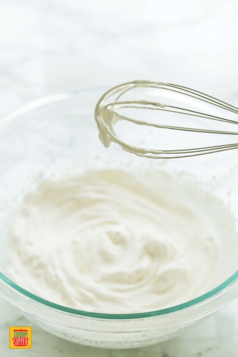 Mixing whipped cream in a bowl with a whisk