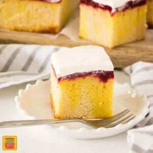 Raspberry Lemon Jello Poke Cake is a combination of soft vanilla cake soaked in lemon jello then topped with an easy homemade raspberry jam and whipped cream.