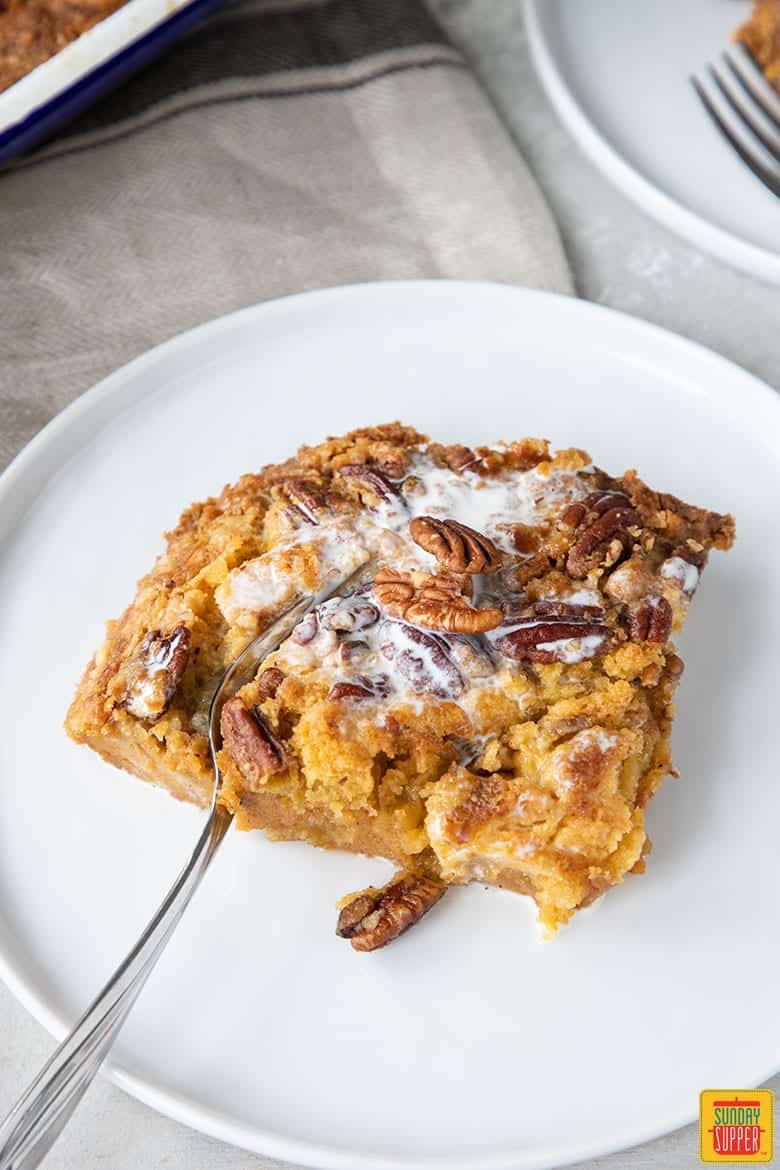 slice of pumpkin crunch on white plate with fork