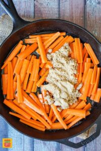 Sliced carrots topped with brown sugar and maple syrup