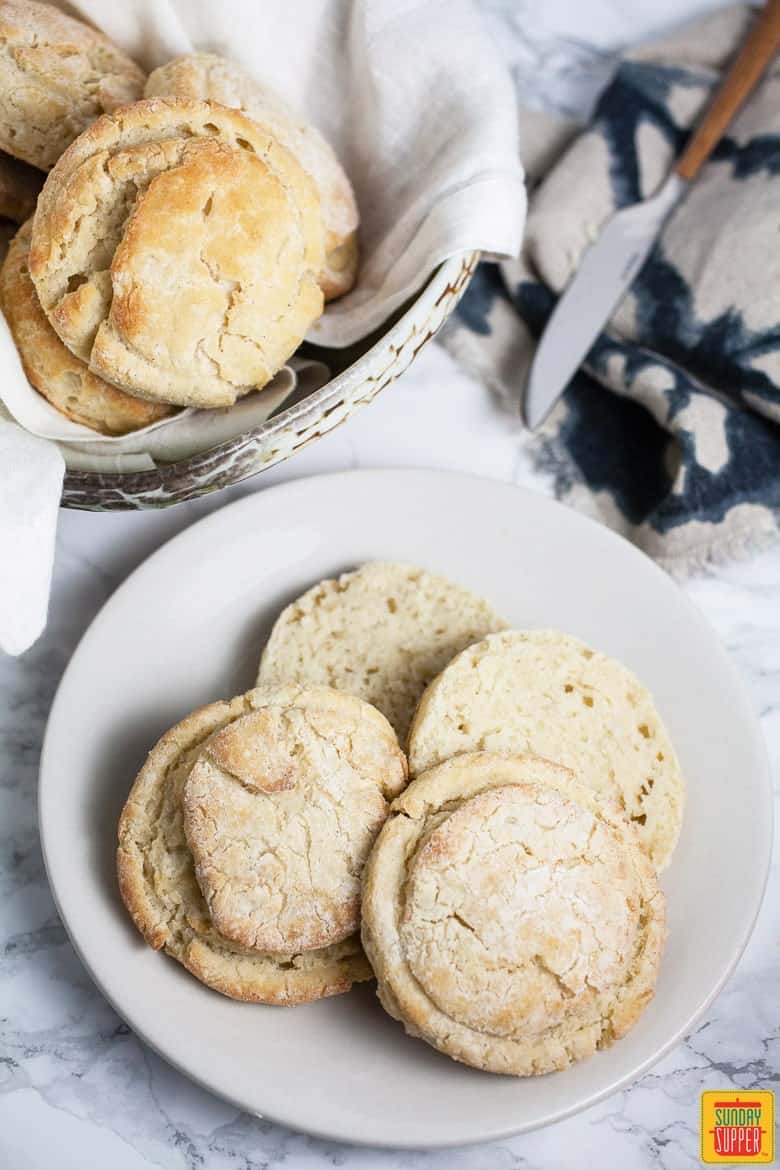 Gluten free foods are an important addition to any meal plan! Add these gluten free side dishes to your dinner party menu and your gluten free guests will be grateful. These delicious gluten free recipes work for any occasion, including your gluten free holiday meals! #SundaySupper #glutenfree #glutenfreerecipes #glutenfreedinner #holidayrecipes #glutenfreediet #glutenfreefoods Gluten free biscuits, ready to eat, served on a plate