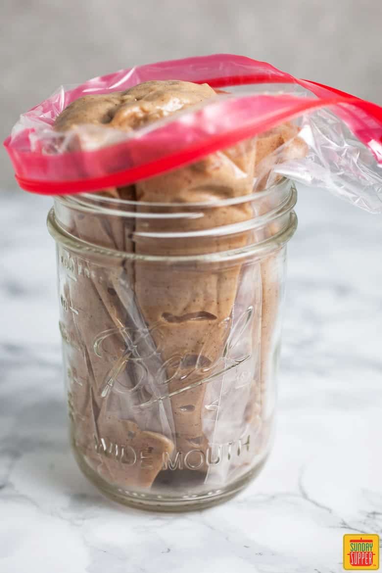 Gluten free donuts batter in a zip-lock bag contained in a mason jar