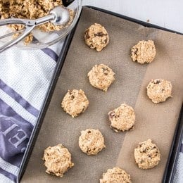 Oatmeal raisin cookies on a tray before baking
