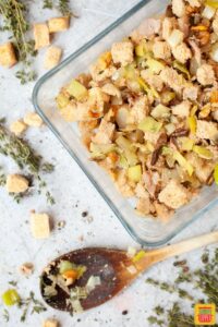 Unbaked gluten-free stuffing in a baking dish