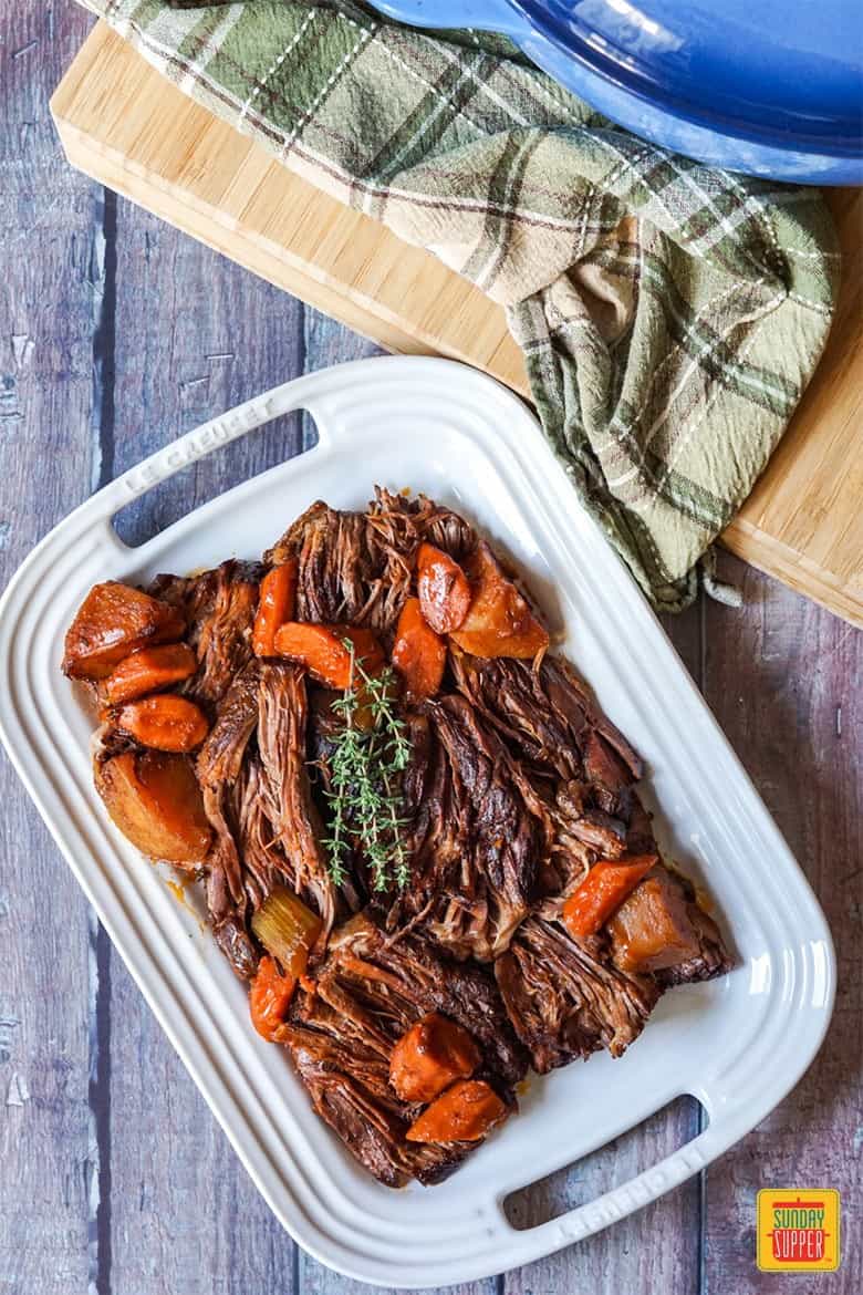 Beef chuck roast on a plate with root vegetables