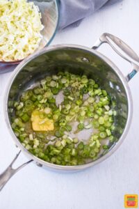 Green onions and butter cooking in pan