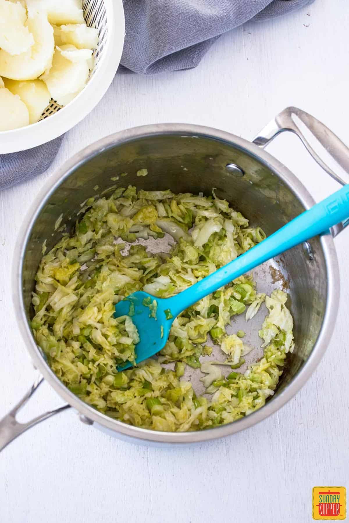 Cabbage added to saucepan