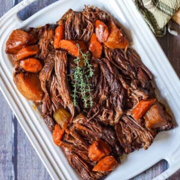 Beef chuck roast on a plate with root vegetables