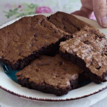 Gluten free fudge brownies on a white plate