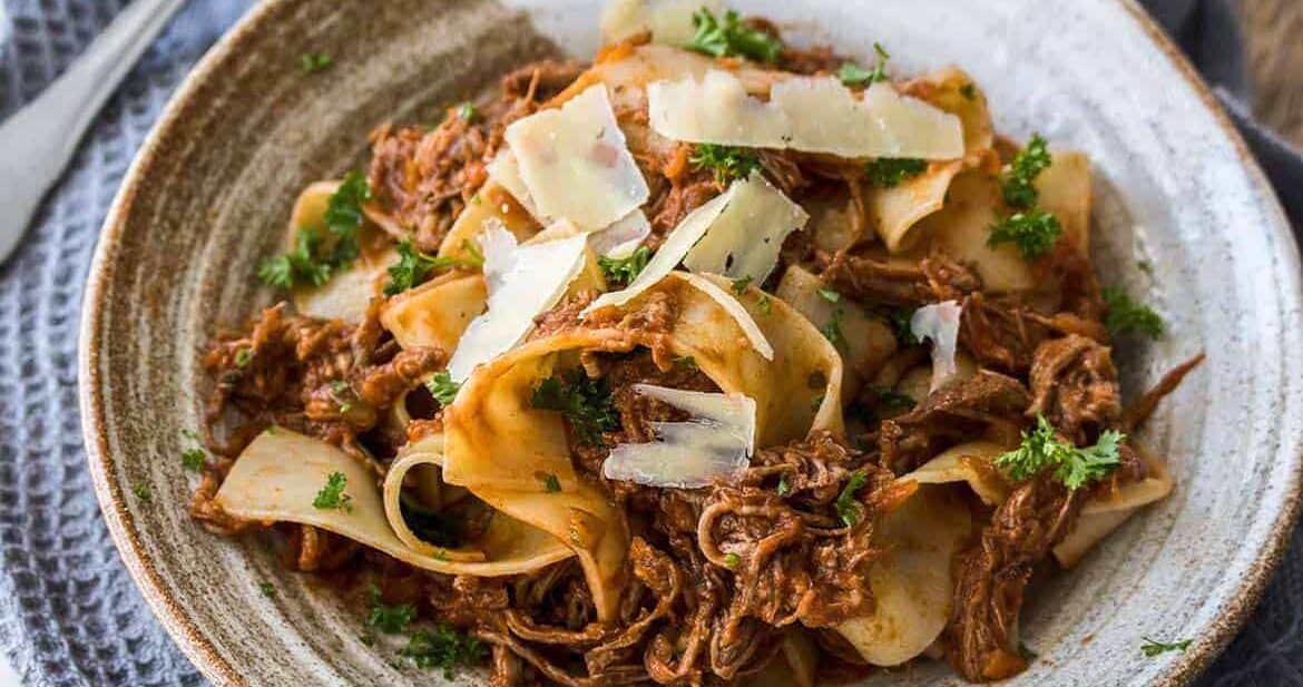 Slow Cooker Beef Ragu is a full flavored, slow cooked ragu perfect for a cold winters night. Served over thick strands of parpadelle, this is comfort food heaven.