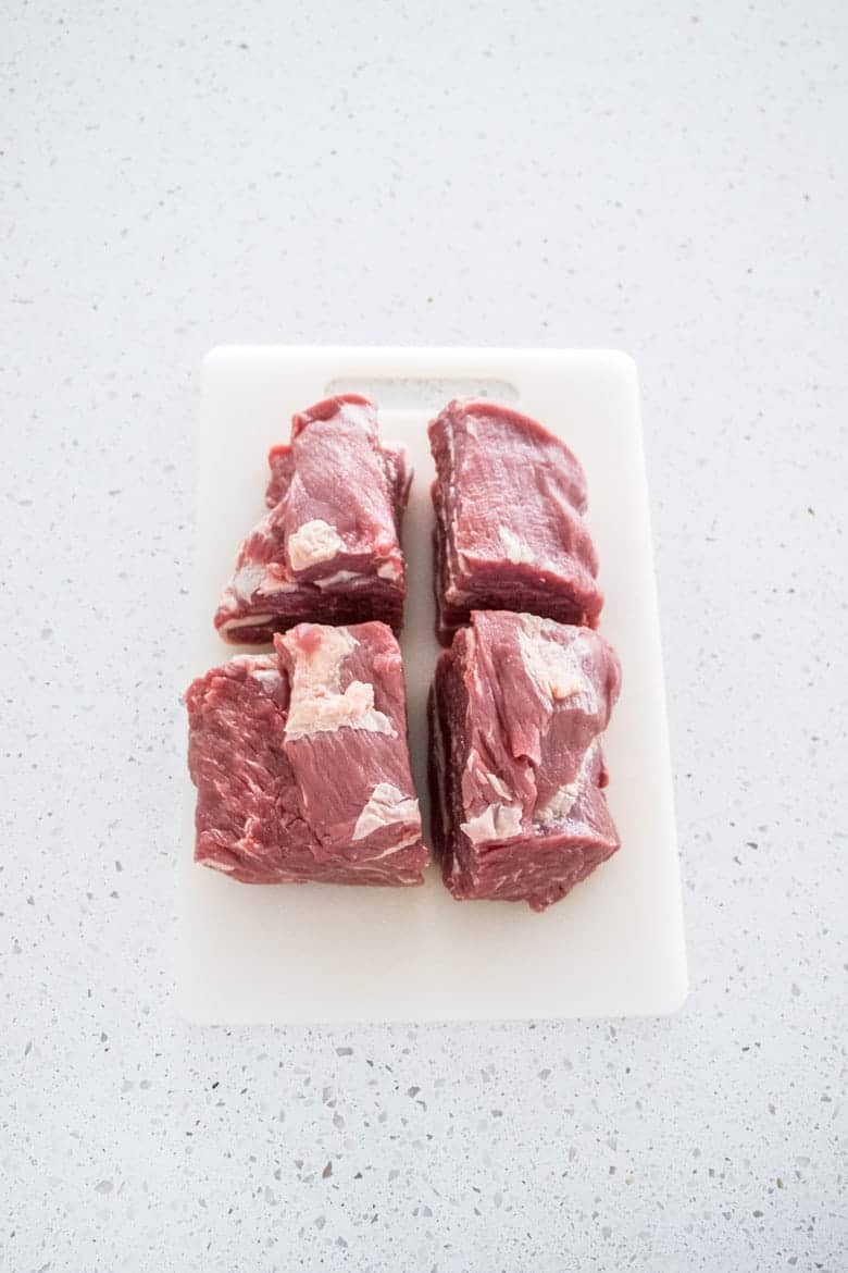 Slow Cooker Beef Ragu raw beef cut into 4 pieces waiting to be seared