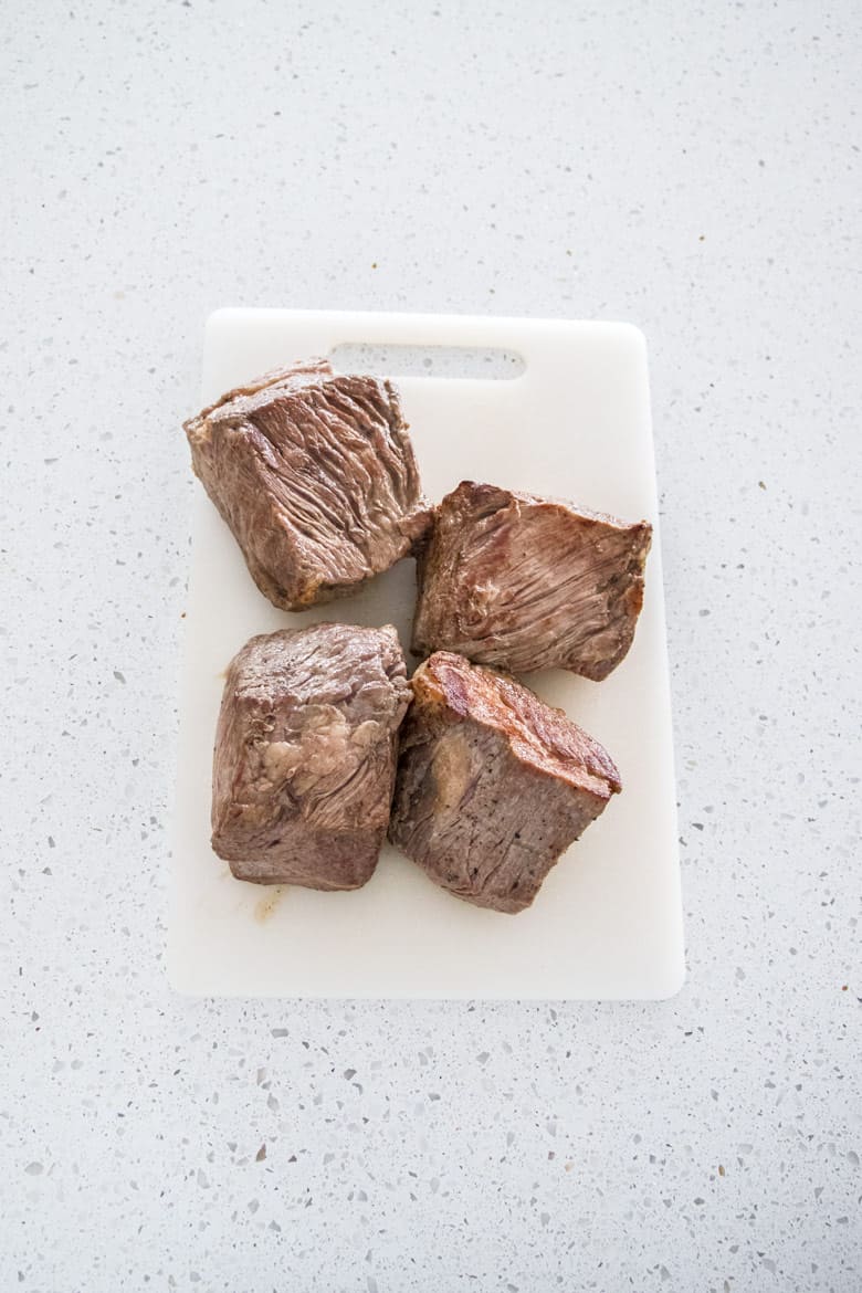 seared beef on a cutting board